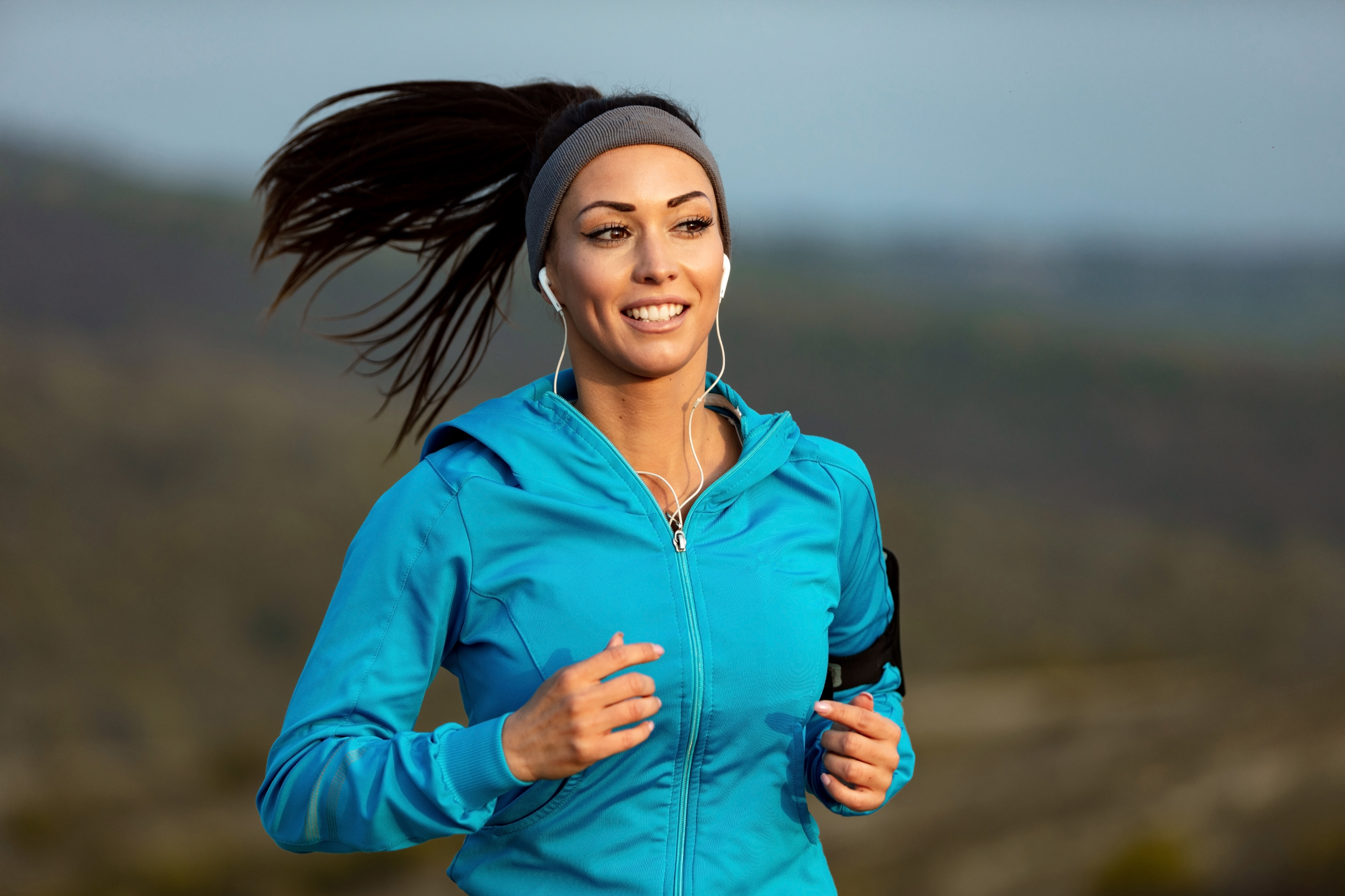 woman in blue jacket jogging as this is her way to cope with basic training